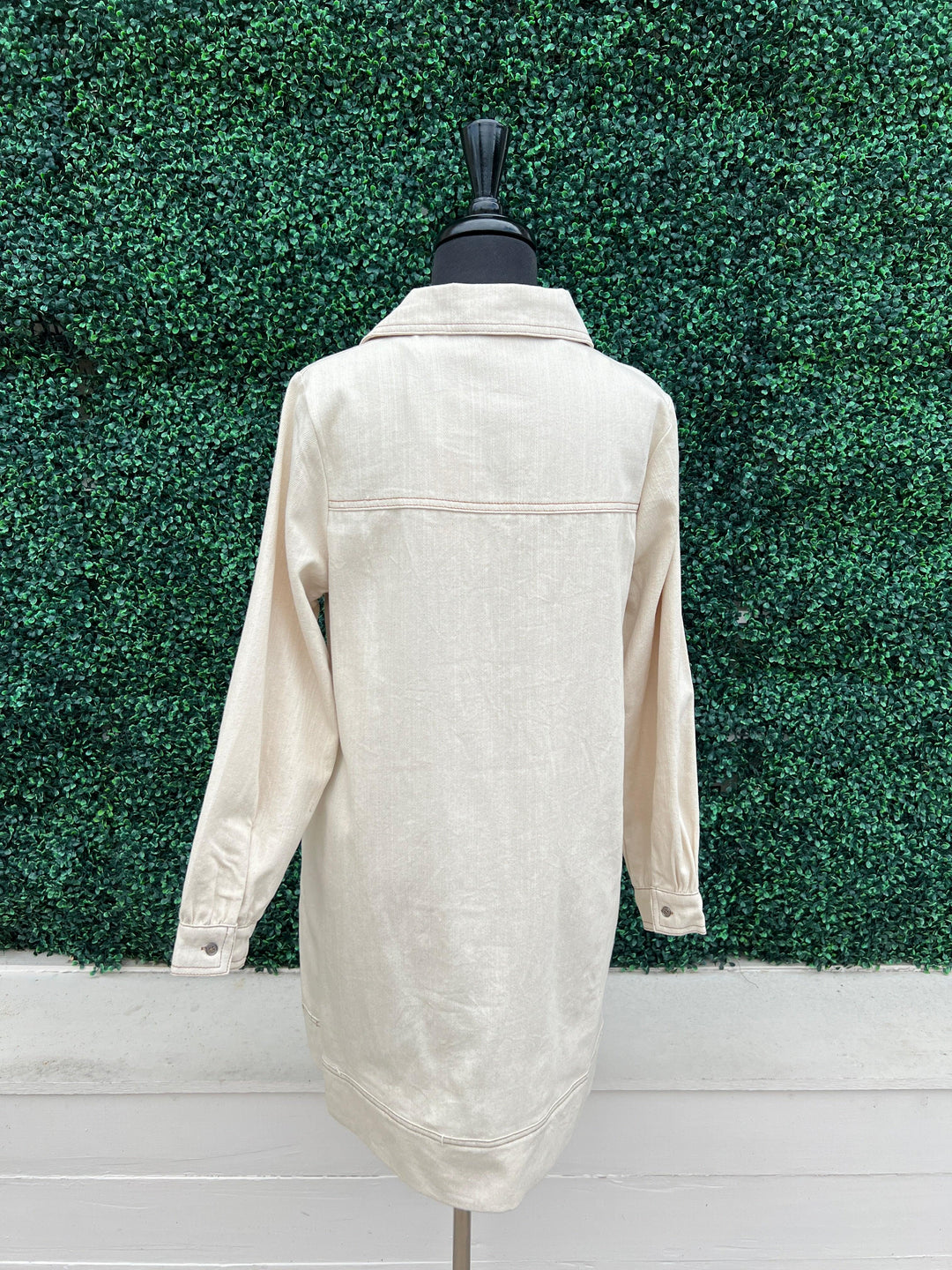 Cream Denim Dress featuring a long sleeve V neck and front pockets by entro brand at tres chic boutique