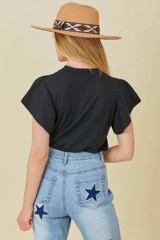Ruffle Sleeve T-Shirt Sweater in black mainstrip brand tucked in to jeans
