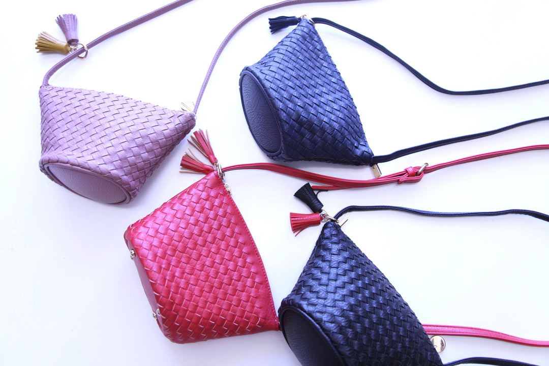 woven triangle purse with a long strap and keychain detail in Tres Chic