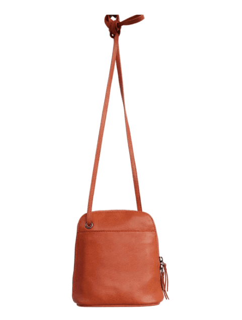boutique with white dresses also sells bright orange leather handbags