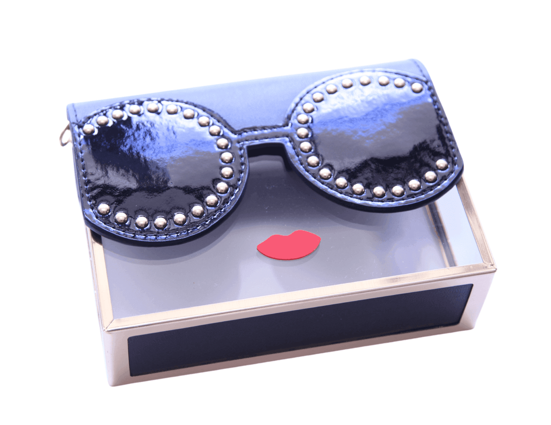 clear acrylic lady with black base and sunglasses