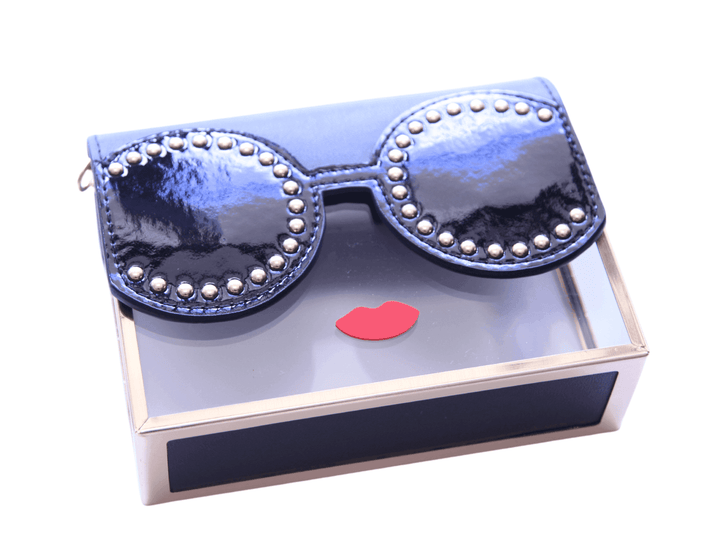 clear acrylic lady with black base and sunglasses