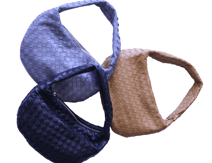 Steel grey, midnight black, and tan woven handbags in online women's boutique