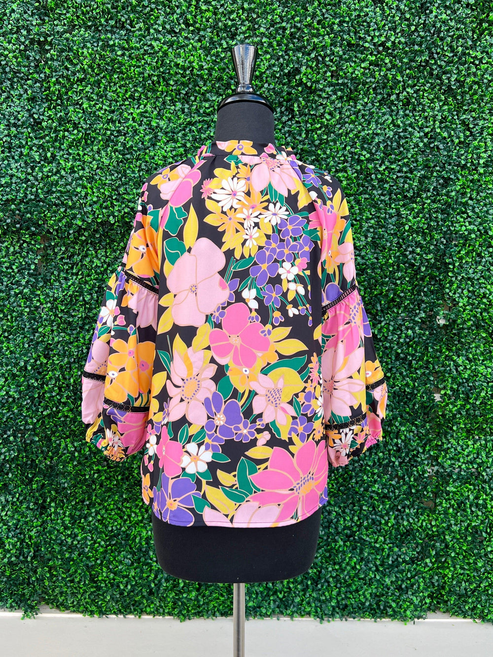 back of orange fall floral statement top