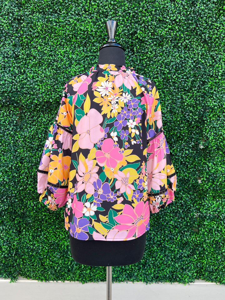 back of orange fall floral statement top
