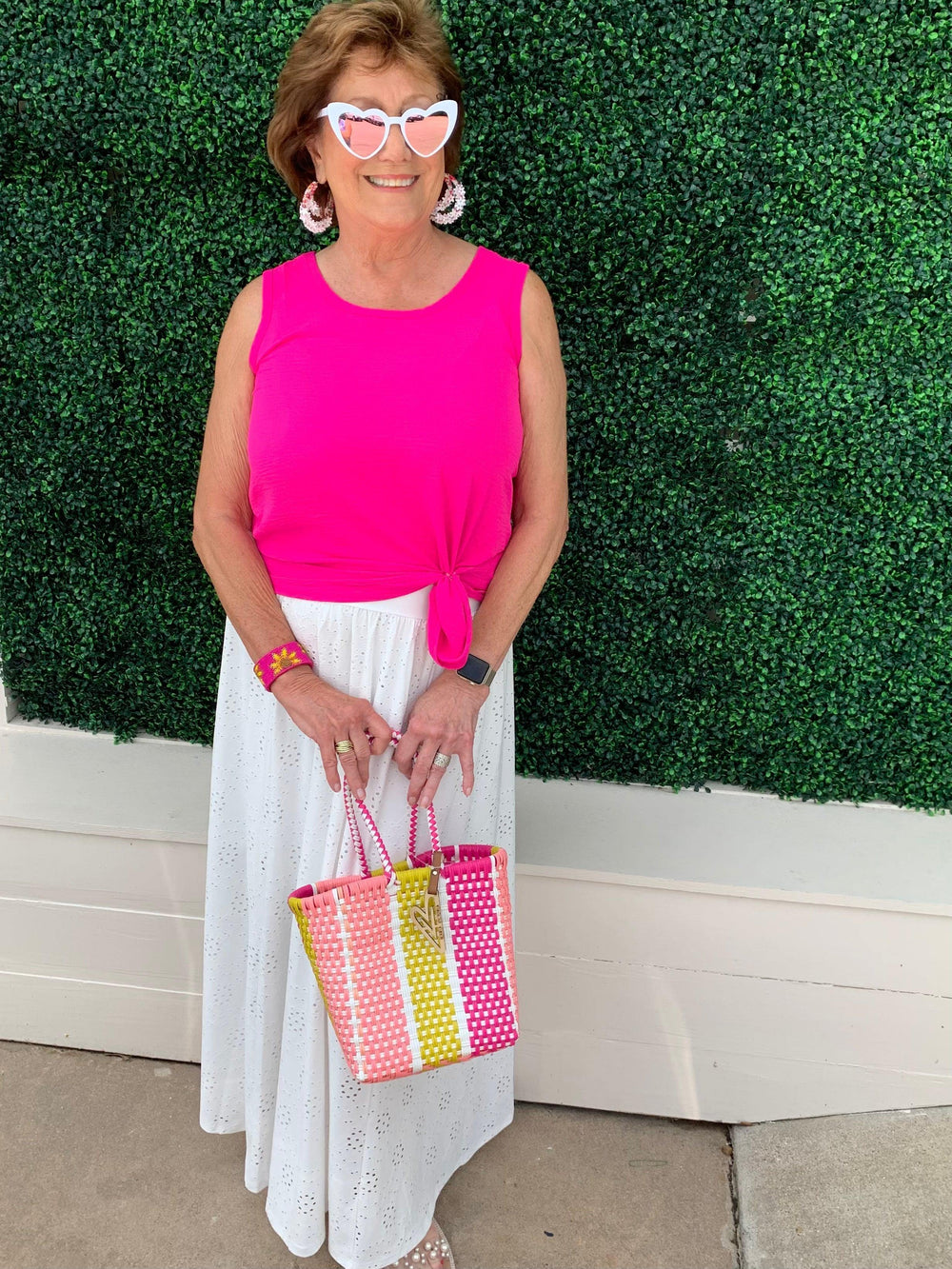 Tres Chic owner wearing tank top with a tie on the side in a summer outfit