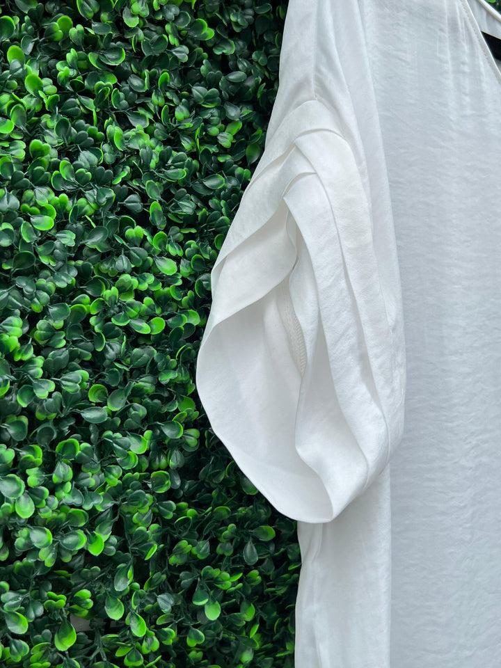 boutique with white dresses and tops