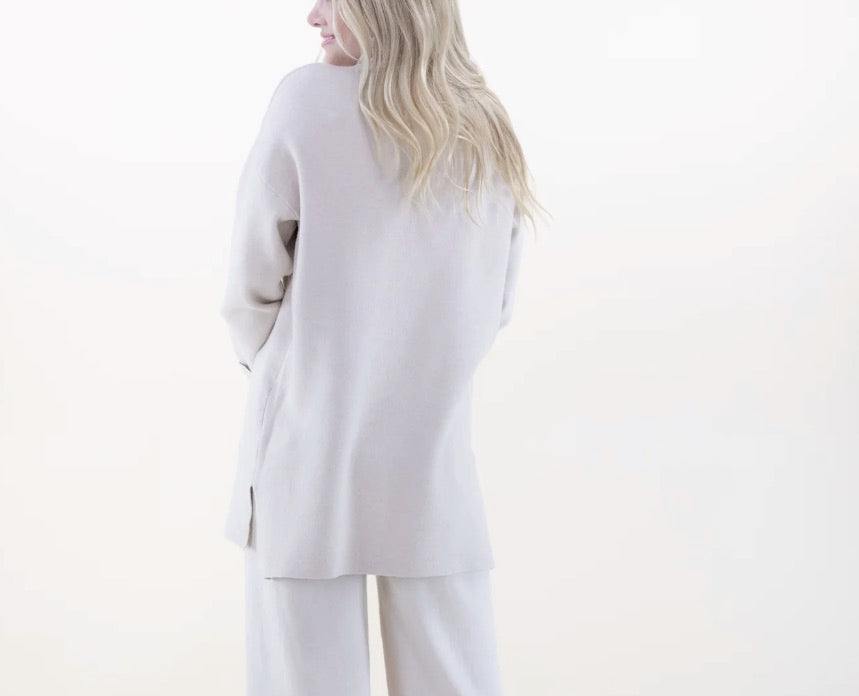 beige Turtleneck Tunic Sweater with gold button detail and silt at sides