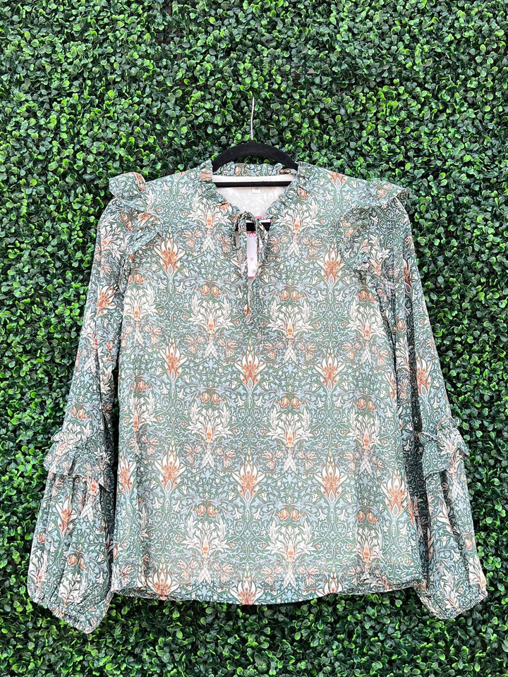 Ruffled V neck print top with ties at neck at Eastside street boutique in Houston 